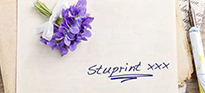 Handwritten wedding invite with purple flower