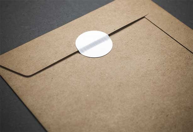 White circular stickers on a brown envelope