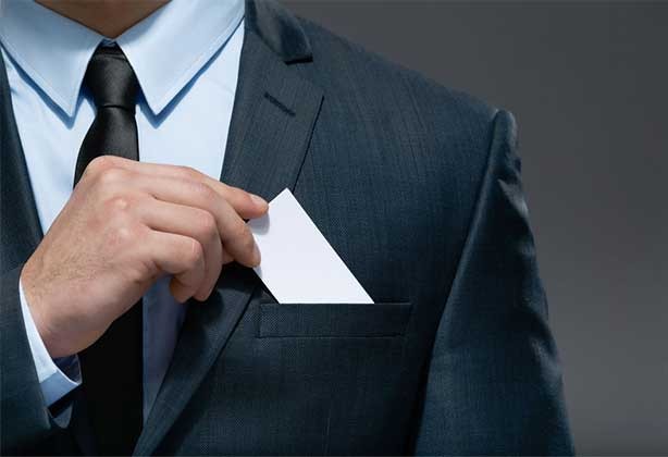 Man putting premium business card in pocket