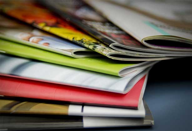 A fanned stack of differe A5, double stapled booklet